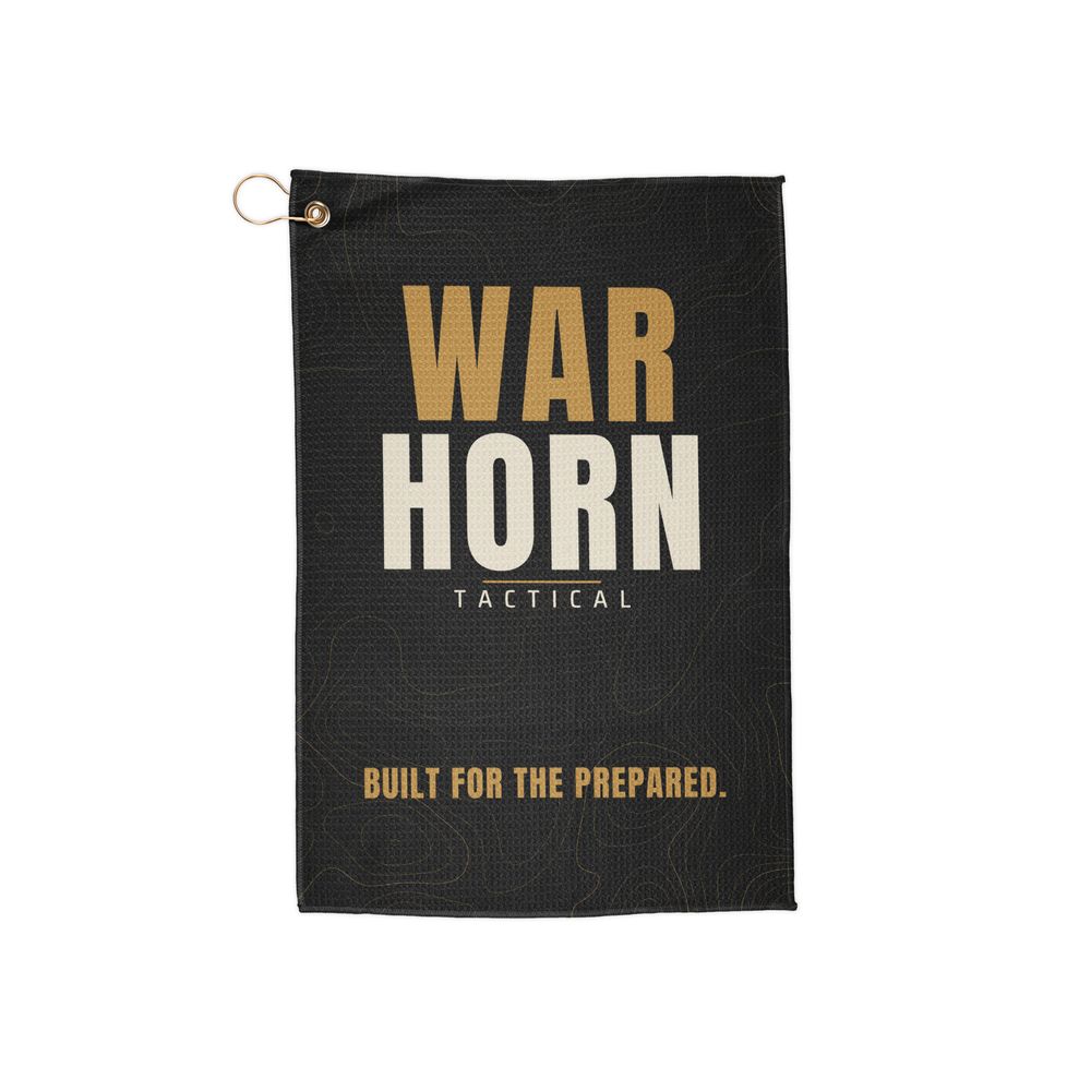 Wordmark Range Towel: black towel with a stacked gold WAR and bone HORN wordmark, TACTICAL, and BUILT FOR THE PREPARED. over faint gold topo lines