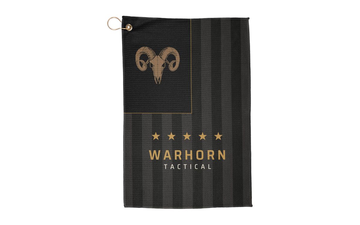 Old Glory Ram Range Towel: subdued black and charcoal vertical flag with a gold ram skull in the union, five gold stars and WARHORN TACTICAL on the stripes