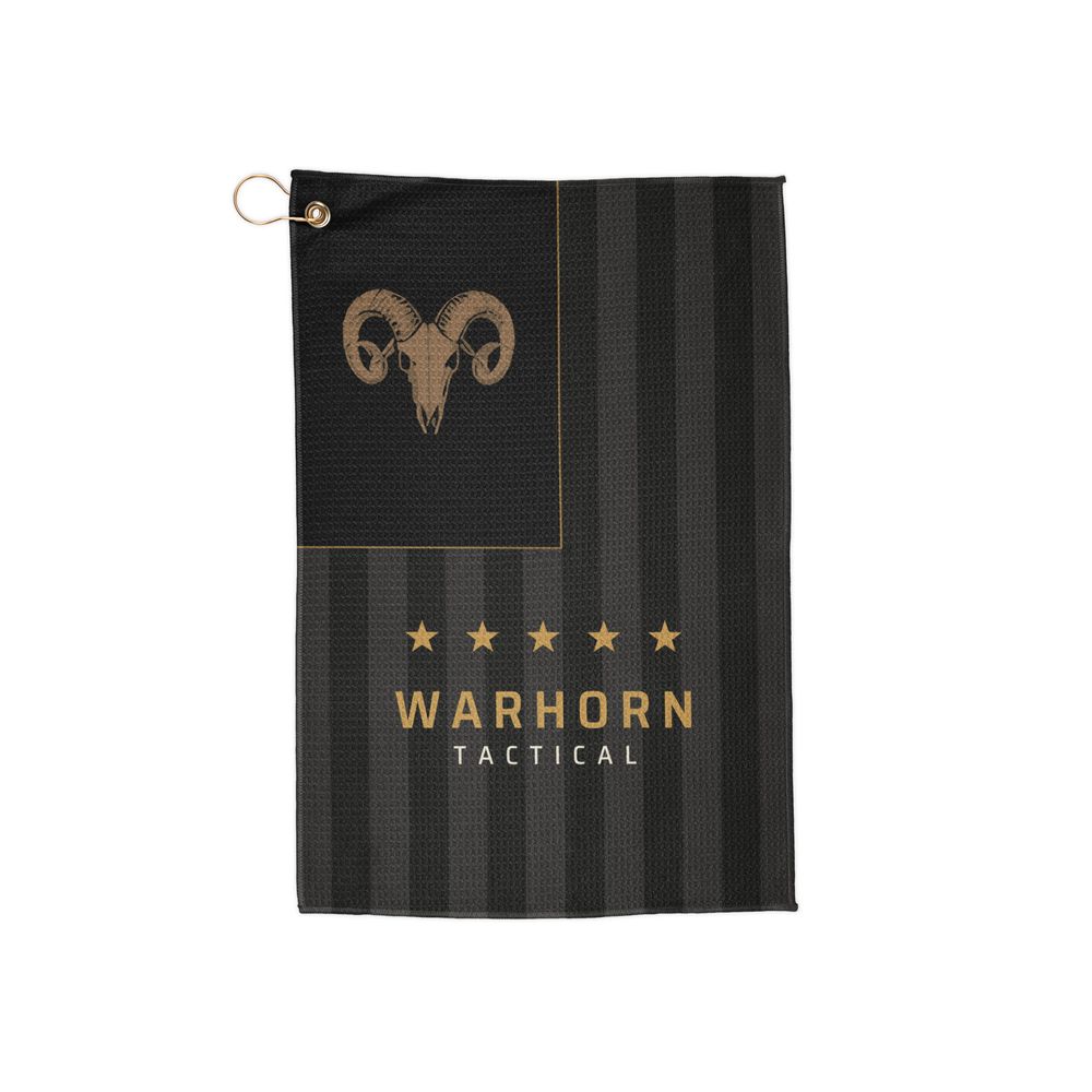 Old Glory Ram Range Towel: subdued black and charcoal vertical flag with a gold ram skull in the union, five gold stars and WARHORN TACTICAL on the stripes