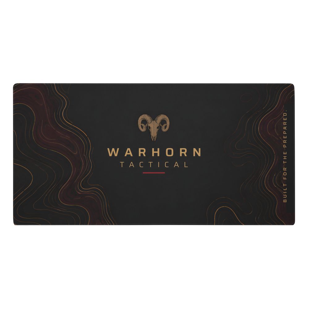 Command Range Mat: black mat with a gold Warhorn ram emblem over the WARHORN TACTICAL wordmark, burgundy topographic edges and a vertical “Built for the Prepared.”, angled photo of the printed mat