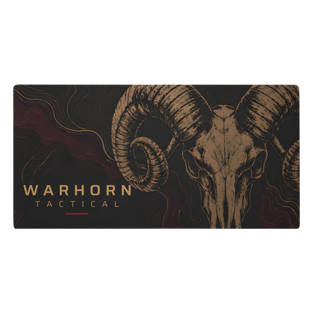 Ram Skull Range Mat: hand-drawn gold ram skull over burgundy topographic lines with the WARHORN TACTICAL wordmark, angled photo of the printed mat